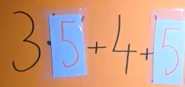 כרטיסייה עם 3·5+4+5 - המספר 5 מושחל בשקיות מעל האותיות